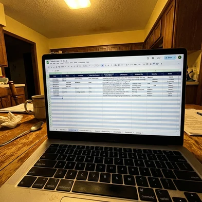Laptop on desk with spreadsheet